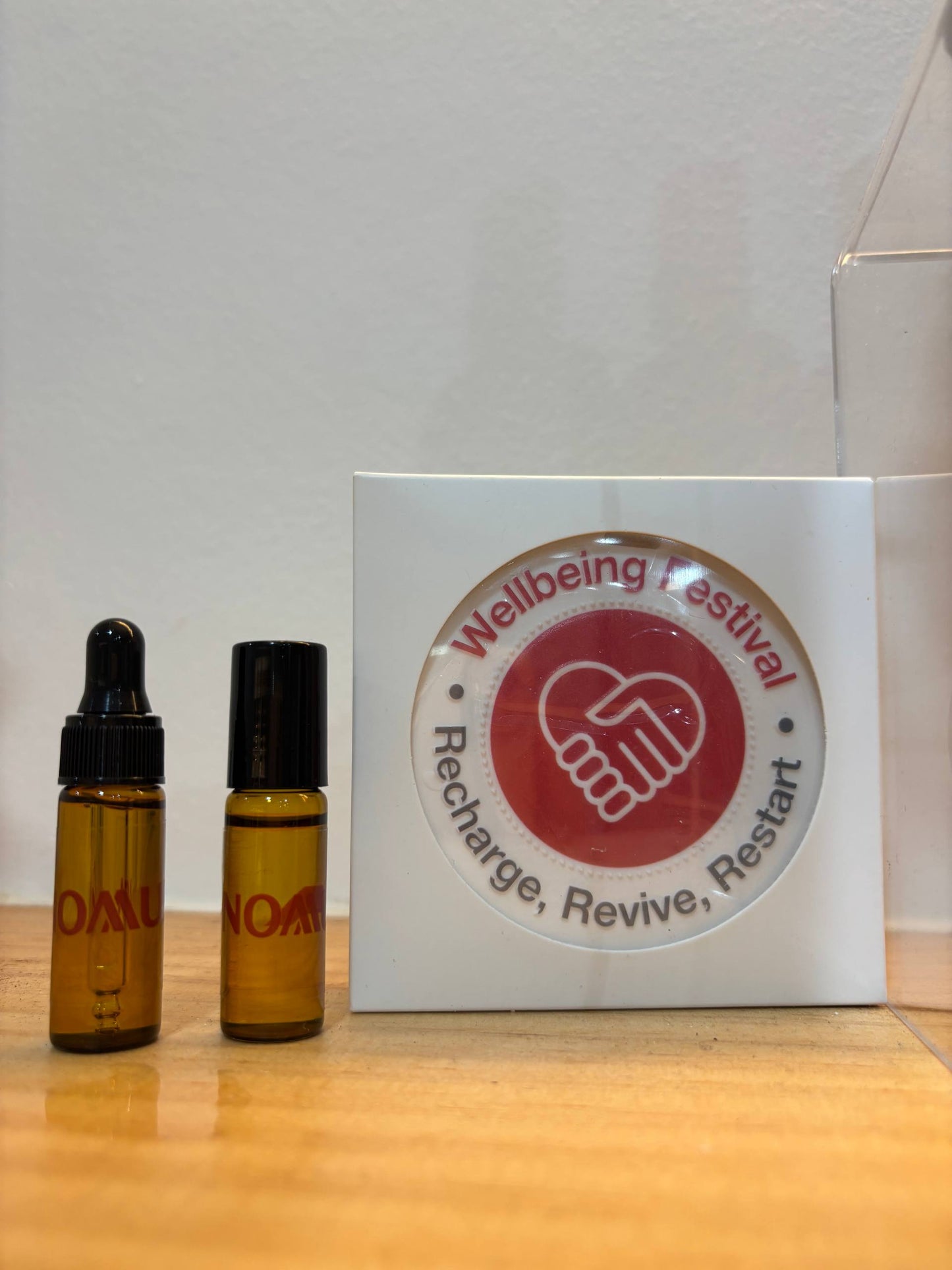 Customised items for Nomura's Wellbeing Festival, comprising of a ceramic diffuser, a 5ml essential oil dropper and roll-on